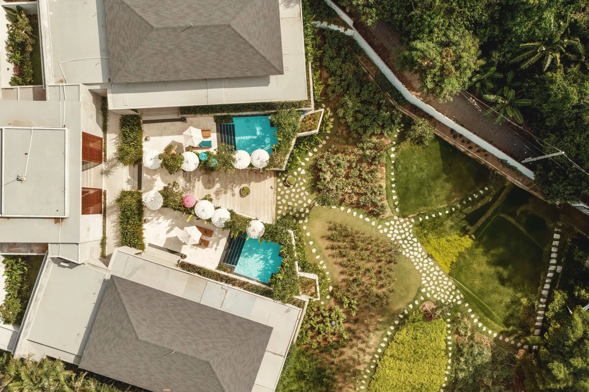 Aerial view of FC Residence's two villas, their pools and tropical gardens