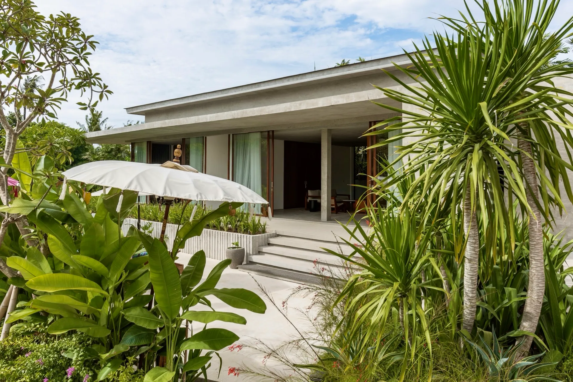 A villa terrace at FC Residence, framed by tropical planting