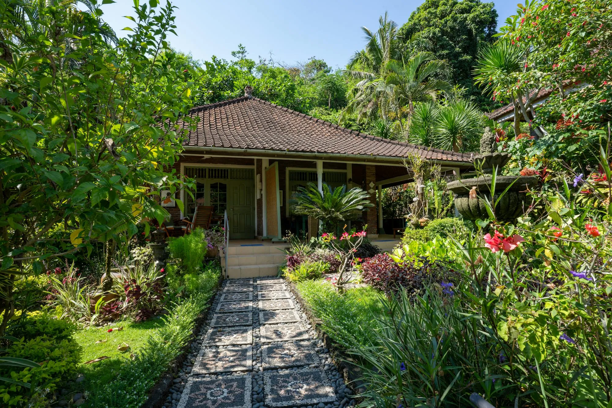 A traditional Balinese garden villa framed by lush tropical planting